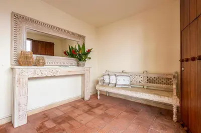a living room with a bench and a fireplace at Casa D Boutique in Cartagena de Indias