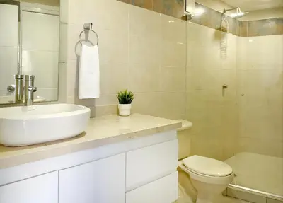 a white bathroom with a sink and a toilet at Riviera Exclusive - Apartamento con vista al mar in Cartagena de Indias