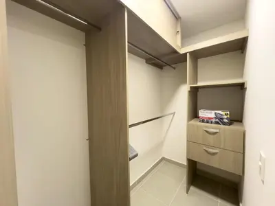 a walk in closet with white walls and wooden shelves at 2 cuartos AC y piscina in Cartagena de Indias