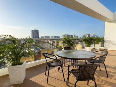 a patio with a table and chairs on a balcony at 2 cuartos terraza piscina AC in Cartagena de Indias