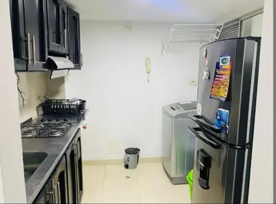 a kitchen with a refrigerator and a stove top oven at Apartamento en Barranquilla in Barranquilla