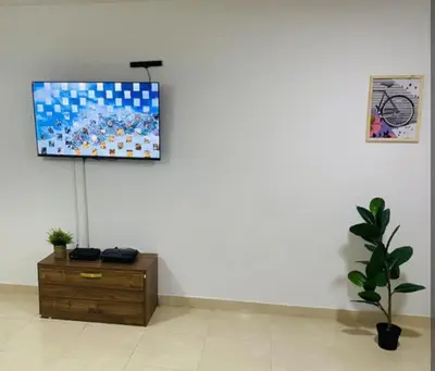 a living room with a tv on a white wall at Apartamento en Barranquilla in Barranquilla