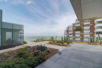an external view of a building with the ocean in the background at Luxury Ocean View Apartment Building H2 - Hyatt in Cartagena de Indias