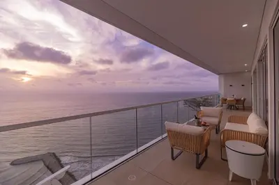 a balcony with chairs and a view of the ocean at Luxury Ocean View Apartment Building H2 - Hyatt in Cartagena de Indias