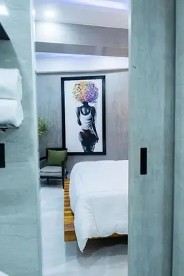 a bedroom with a bed and a painting on the wall at Luxury Apartment BayView Jacuzzi Guestfriendly in Cartagena de Indias