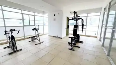 a gym with tread machines in a room with windows at Departamento con vista al mar in Cartagena de Indias