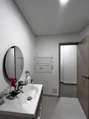 a white bathroom with a sink and a mirror at Apt luxury wifi AC pool at Cartagena in Cartagena de Indias