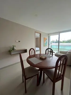 a dining room with a wooden table and chairs at Apto Caribe Mar in Coveñas