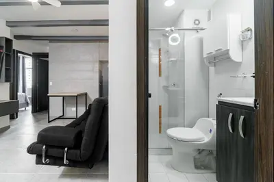 two views of a bathroom with a toilet and a sink at Apt luxury near sea wifi Ac pool at Cartagena in Cartagena de Indias