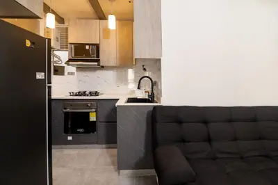 a kitchen with a couch in the middle of it at Apt luxury near sea wifi Ac pool at Cartagena in Cartagena de Indias