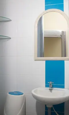 a bathroom with a sink and a mirror at Hotel Catedral inn B SAS in Barranquilla