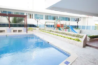 a swimming pool with a playground in front of a building at Riviera Summer - Apartamento con balcón in Cartagena de Indias