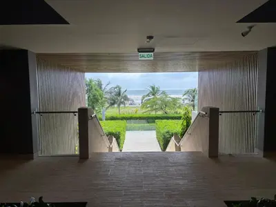 an empty hallway with a sign that reads exit at Beachfront Stay Morros EOS in Cartagena de Indias