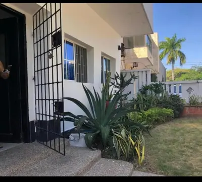 a house with a plant in front of a door at Apartamento de lujo alto prado in Barranquilla