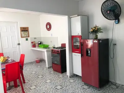 a kitchen with a red refrigerator and a table at Bogavante Getsemani para familias in Cartagena de Indias