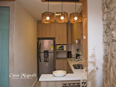 a kitchen with a stainless steel refrigerator and two lights at Casa Migueli, exclusiva casa con jacuzzi en terraza in Cartagena de Indias