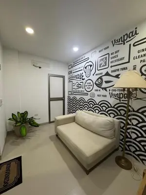 a living room with a couch in front of a wall at aparta estudio susheria in Sincelejo