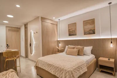 a bedroom with a large bed and a bathroom at Maranta Beach in Santa Marta
