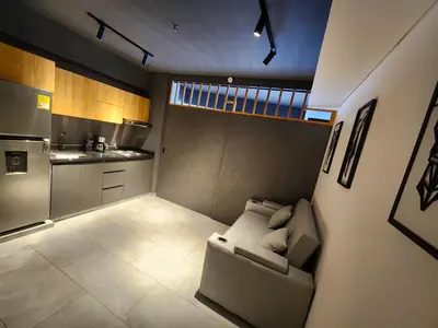 a small living room with a couch and a kitchen at Exclusive apartment Cartagena in Cartagena de Indias