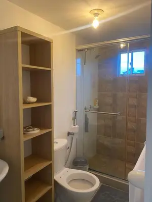 a bathroom with a toilet and a glass shower at Playa Azul in Puerto Colombia