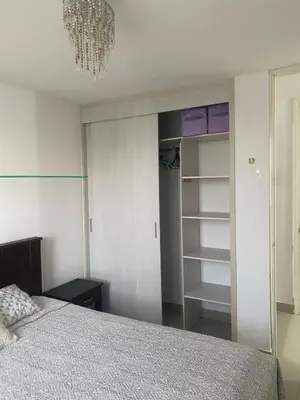 a bedroom with a bed and a chandelier at Playa Azul in Puerto Colombia