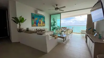 a living room with a couch and a view of the ocean at Magico Apartamento Frente al Mar 3 Habitaciones MSC64 in Coveñas