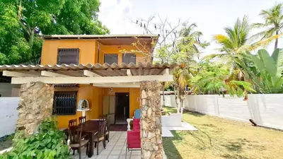 a house with a table and chairs in front of it at Casa Guadalupe Coveñas in Coveñas