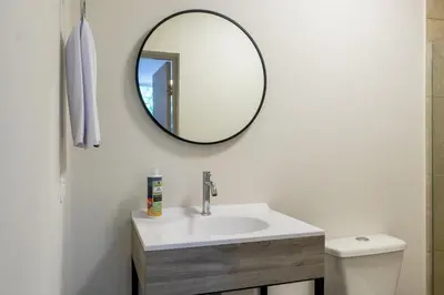 a bathroom with a sink and a mirror on the wall at New Pueblito Suites - Cerca a la Playa in Cartagena de Indias