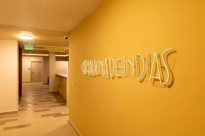 a sign on a wall in an office lobby at New Pueblito Suites - Cerca a la Playa in Cartagena de Indias