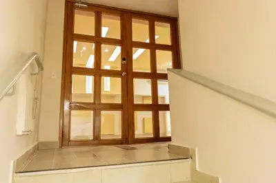 a staircase with a wooden door and a window at New Pueblito Suites - Cerca a la Playa in Cartagena de Indias