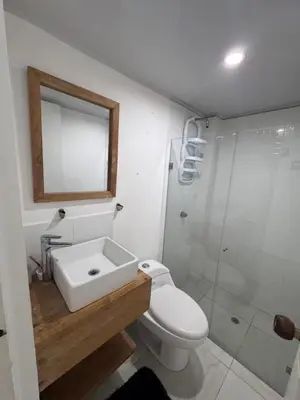a bathroom with a toilet and a sink and a shower at Apartamento Caribe Coveñas 102 in Coveñas