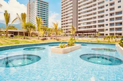 a swimming pool in a resort with tall buildings at Exclusiva Suite Frente al Mar in Santa Marta