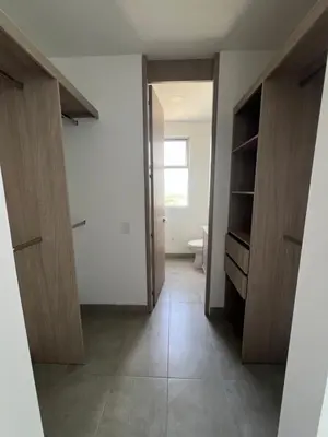 a bathroom with a toilet and a hallway with wooden cabinets at Apto 1417 condominio Santa marina, Santa Marta in Estación El Salto