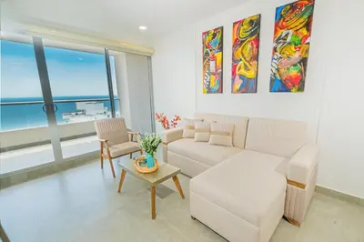 a living room with a couch and a table at Apto 1417 condominio Santa marina, Santa Marta in Estación El Salto