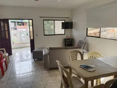 a living room with a couch and a table and chairs at Apartamento Villa Saika in Coveñas