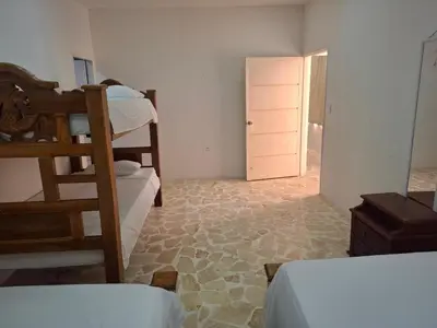 a room with two bunk beds and a doorway at Finca Villa Gabriela