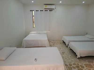 a room with three beds in a room at Finca Villa Gabriela