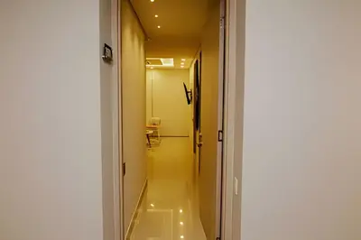 a hallway with a door leading to a bathroom at Beachfront Bocagrande Stay | Breathtaking Sunsets in Cartagena de Indias