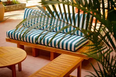 a bench sitting on a patio with a plant at Masaya Cartagena in Cartagena de Indias