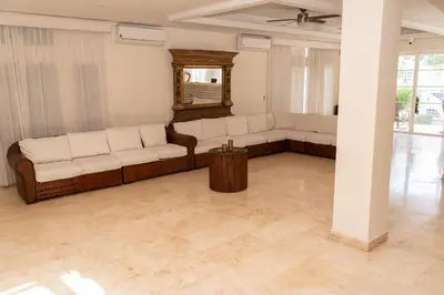 a living room with white couches and a mirror at Villa exclusiva junto al mar en Cartagena in Cartagena de Indias