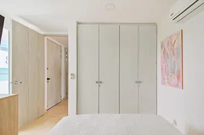 a white bedroom with white cabinets and a bed at Sonesta Resort Apartamento Morros Cartagena in Cartagena de Indias