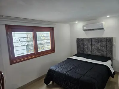 a bedroom with a bed and a window at Migo in Cartagena de Indias