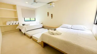 two beds in a room with white walls at Cabaña Tierramia 3 in San Silvestre