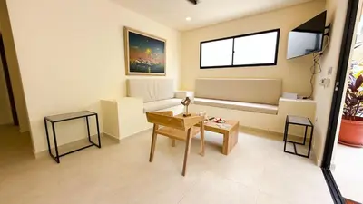 a living room with a couch and a table at Cabaña Tierramia 3 in San Silvestre