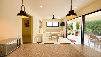 a kitchen and living room with a table and chairs at Cabaña Tierramia 3 in San Silvestre