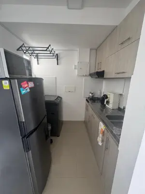 a small kitchen with a stainless steel refrigerator at nice and affordable in Cartagena de Indias