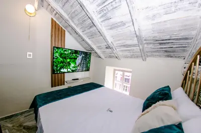 a bedroom with a bed and a flat screen tv at Sublime Hotel Cartagena in Cartagena de Indias
