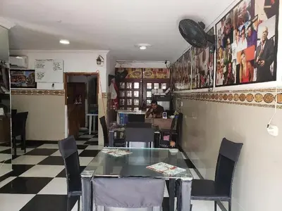 a dining room with a glass table and chairs at Hotel Girasol Inn Barranquilla in Barranquilla
