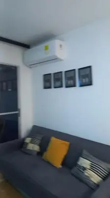 a blue couch with yellow pillows in a living room at Hermoso apartamento in Cartagena de Indias