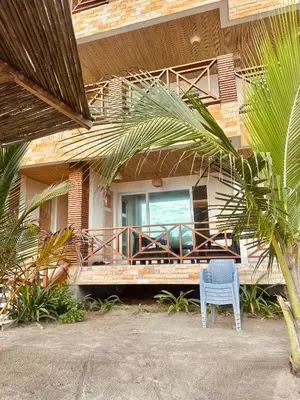 a blue chair sitting in front of a house at Fotosíntesis - Apartamento frente al mar en Tolú in San Silvestre